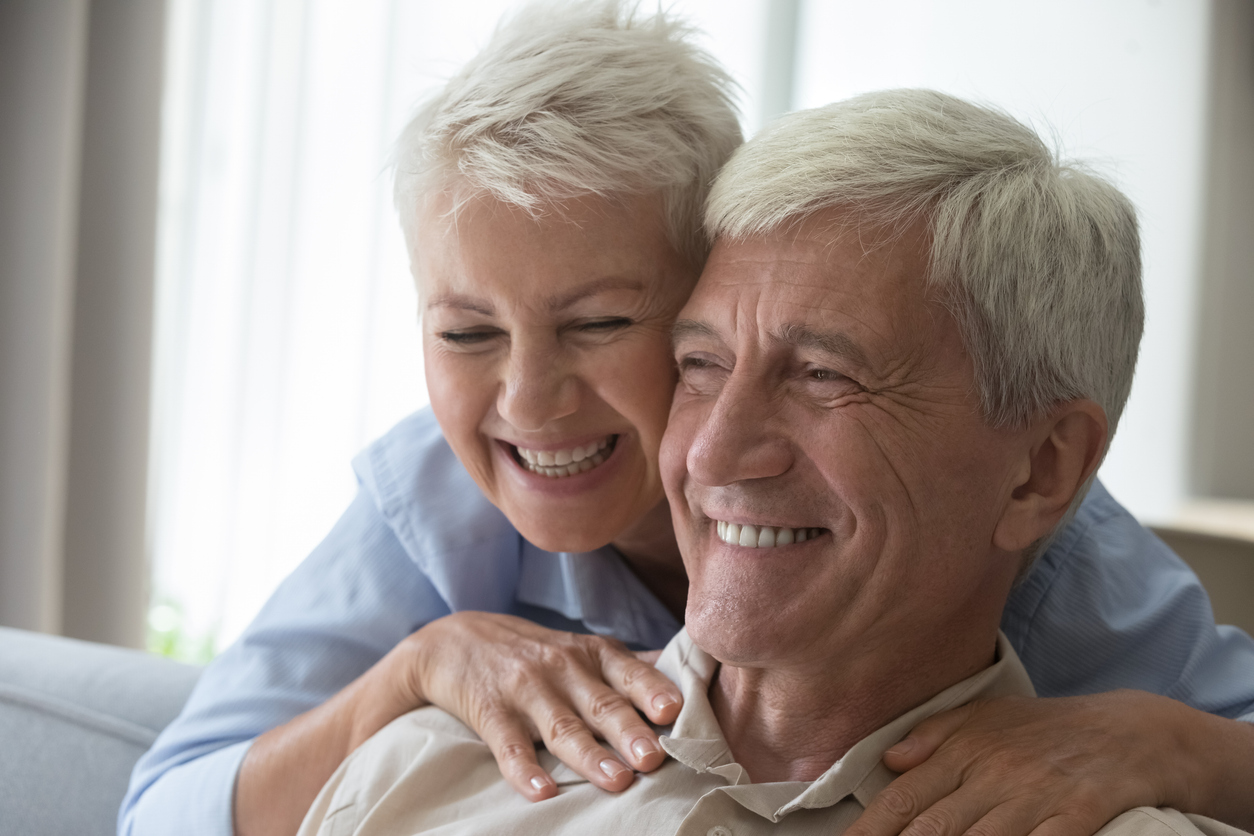 Closeup shot affectionate smiling aged wife embrace husband from behind